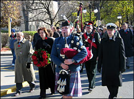 Led by a piper, Principal Munroe-Blum, war veterans, McGill faculty, students and staff make a solemn procession to the Arts Building.