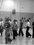 Group of students practicing in gymnasium during an instructional dance class. (photo n.d.). MUA PU024174.
