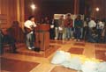 Japanese Canadian singer entertains at Ottawa Redress Rally, April 14, 1988, in front of letters in support of Redress.